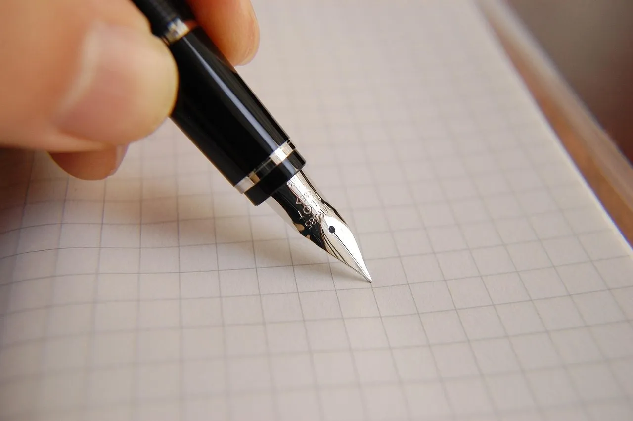 A legal pad and pen on a desk